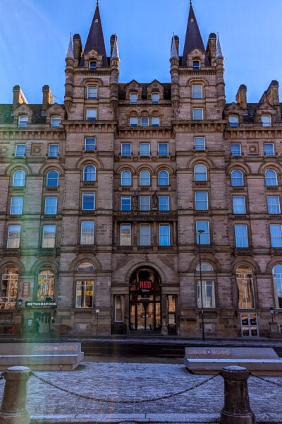 grand historic building of beige stone with 6 floors and an elaborate facade with snow on the road in front and clear blue sky above. Liverpool city break travel guide